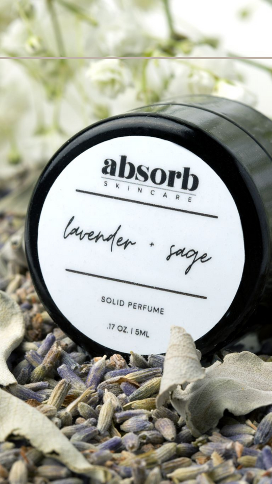 picture of the solid perfume in a pile of lavender buds and sage leaves